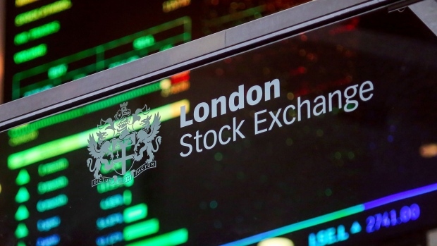 A London Stock Exchange sign sits on glass in the atrium of the London Stock Exchange Group Plc's offices in Paternoster Square in London, U.K., on Monday, July 25, 2016. Deutsche Boerse AG has yet to secure shareholder acceptance for its 10.6 billion-pound ($13.9 billion) takeover of London Stock Exchange Group Plc, although it edged closer with 55.5 percent of investors giving it the go ahead. Photographer: Bloomberg/Bloomberg