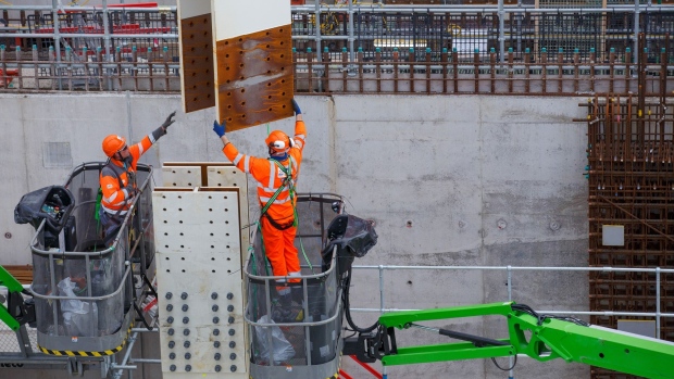 Contractors move a steel joist into position at Hinkley Point C nuclear power station construction site, near Bridgwater U.K., on Thursday, Sept. 23, 2021. U.K. power prices have climbed so high that the cost of the nuclear plant, criticized for being too expensive, is now looking reasonable.