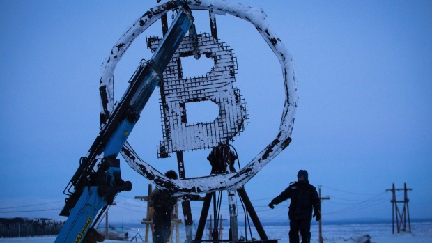 A bitcoin sculpture made from scrap metal is installed outside the BitCluster cryptocurrency mining farm in Norilsk, Russia.