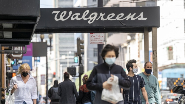 Pedestrians pass a Walgreens store in San Francisco. Photographer: David Paul Morris/Bloomberg