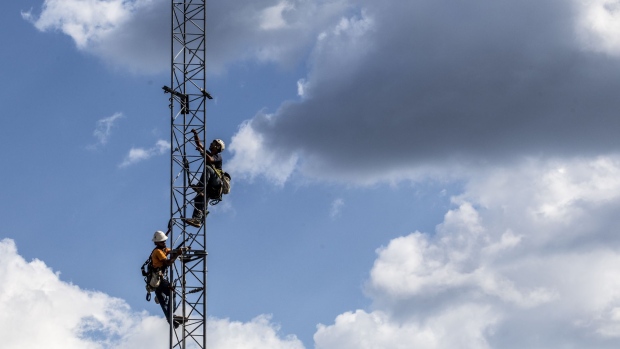 Verizon Communications Inc. workers install a temporary cell tower after Hurricane Florence hit in Newport, North Carolina, U.S., on Wednesday, Sept. 19, 2018. President Donald Trump lauded the federal response to Hurricane Florence on Wednesday as he began a tour of areas in North and South Carolina hit over the weekend by high winds and torrential rain.