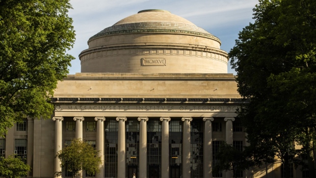 A person passes in front of the Great Dome on Killian Court at the Massachusetts Institute of Technology (MIT) campus in Cambridge, Massachusetts, U.S., on Wednesday, June 2, 2021. In 2014, every undergraduate on the Massachusetts Institute of Technology campus had the chance to claim fractional ownership of a Bitcoin in an experiment referred to as the MIT Bitcoin Project. Photographer: Adam Glanzman/Bloomberg