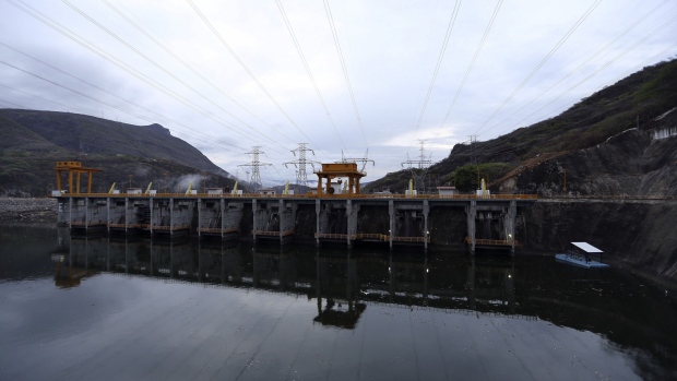 Electrical transmission towers stand at the Comision Federal de Electricidad's (CFE) Manuel M. Torres Dam and hydroelectric power station in the state of Chiapas near Chicoasen, Mexico, on Monday, May 27, 2013.