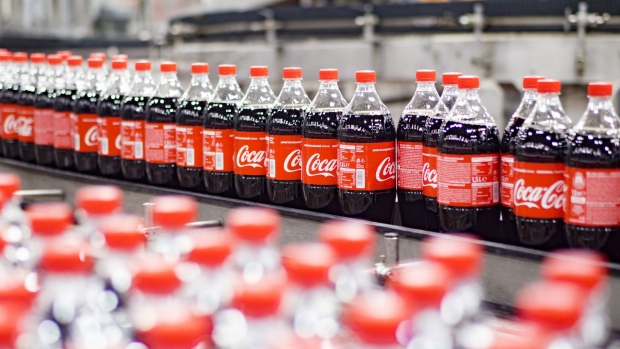 Plastic bottles of Coke soda move along the automated production line at the Coca-Cola Hellenic Bottling Co. SA plant in Brovary, Ukraine, on Wednesday, May 10, 2017. Heineken NV, Coca-Cola HBC AG and Castel Group are among companies bidding for a majority stake in Coca-Cola Beverages Africa, according to people familiar with the matter. Photographer: Vincent Mundy/Bloomberg