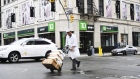 A pedestrian pushes boxes on a trolley in front of a TD Ameritrade Holding Corp. bank branch in New York, New York, US., on Saturday, April 20, 2019. TD Ameritrade Holding Corp. is scheduled to release earnings figures on April 23.