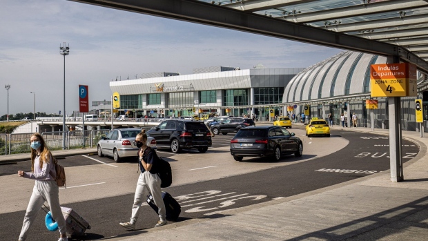 Vehicles drop off passengers outside Budapest Ferenc Liszt International Airport in Budapest, Hungary, on Wednesday, Aug. 4, 2021. The Hungarian government has made a non-binding offer to buy Budapest Airport, according to people familiar with the matter, as Prime Minister Viktor Orban seeks to gain control of what had been one of the fastest growing hubs in the region before the coronavirus pandemic.