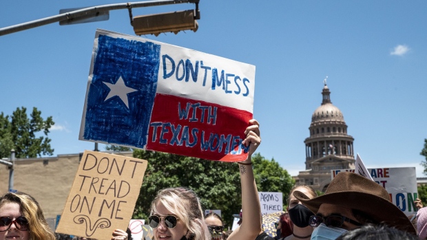 AUSTIN, TX - MAY 29: Protesters hold up signs as they march down Congress Ave at a protest outside the Texas state capitol on May 29, 2021 in Austin, Texas. Thousands of protesters came out in response to a new bill outlawing abortions after a fetal heartbeat is detected signed on Wednesday by Texas Governor Greg Abbot. (Photo by Sergio Flores/Getty Images) Photographer: Sergio Flores/Getty Images North America