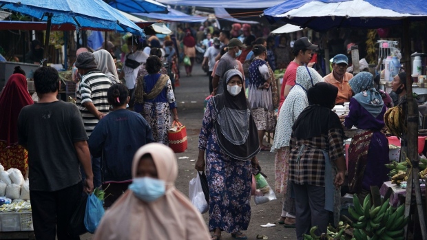 Shoppers at Karangayu Market in Semarang, Central Java, Indonesia, on Thursday, July 22, 2021. Indonesia will use a four-level movement restriction strategy that varies from city to city based on how badly affected they are by the coronavirus outbreak, before a plan to begin easing the curbs next week. Java and Bali are placed at the highest levels of 3 and 4. Photographer: Dimas Ardian/Bloomberg