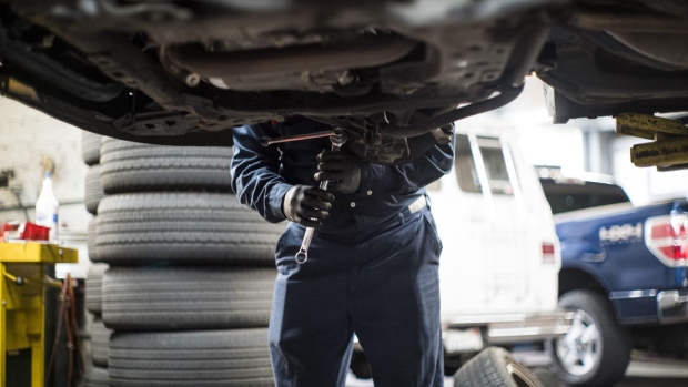 An employee works on a vehicle at a Goodyear auto service location in San Francisco, California, U.S., on Thursday, July 23, 2020. Goodyear Tire & Rubber Co. is expected to release earnings figures on July 27. Photographer: David Paul Morris/Bloomberg