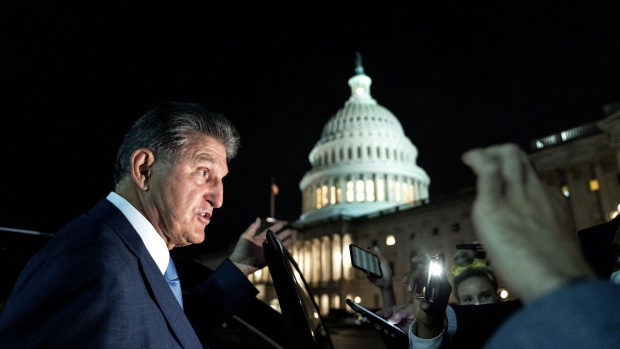 Senator Joe Manchin, a Democrat from West Virginia, speaks to members of the media while departing the U.S. Capitol in Washington, D.C., U.S., on Thursday, Oct. 7, 2021. The U.S. Senate approved legislation that pulls the nation from the brink of a first-ever payment default with a short-term debt-ceiling increase, breaking a weeks-long stalemate that rattled financial markets.