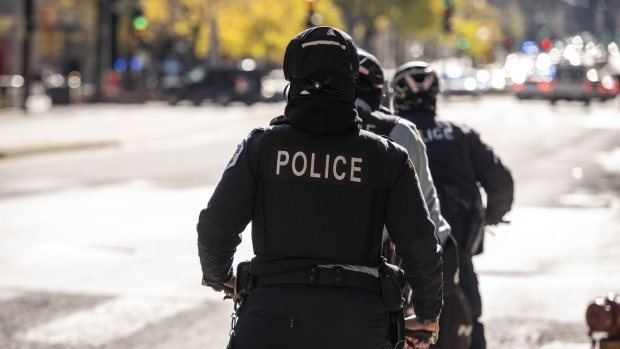 Chicago police officers patrol Michigan Avenue in Chicago, Illinois, U.S., on Nov. 2, 2020. After being caught off guard during nationwide social unrest this summer and suffering millions in damages, retailers have spent months prepping for another possible bout of vandalism on Election Day. Photographer: Christopher Dilts/Bloomberg