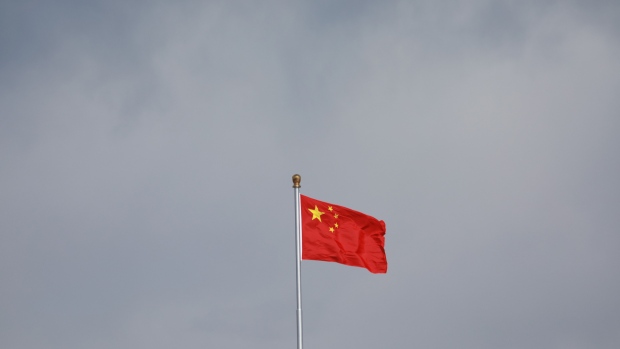 A Chinese flag flies in Tiananmen Square in Beijing, China, on Thursday, March 14, 2019. China is planning to approve new rules for foreign investment in the country this week, a sweeping overhaul of regulations that will affect corporate titans from Ford to Alibaba and Tencent. Photographer: Giulia Marchi/Bloomberg