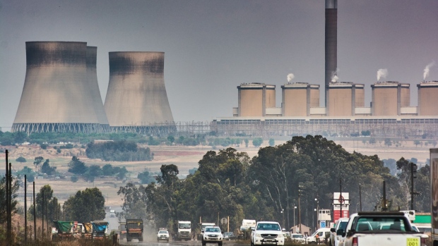 Traffic passes the Kendal coal-fired power station, operated by Eskom Holdings SOC Ltd., in Mpumalanga, South Africa, on Thursday, Sept. 30, 2021. South Africa is under pressure to cut its dependence on coal -- which accounts for more than 80% of its power generation – but it needs finance to facilitate the transition to cleaner energy. Photographer: Waldo Swiegers/Bloomberg