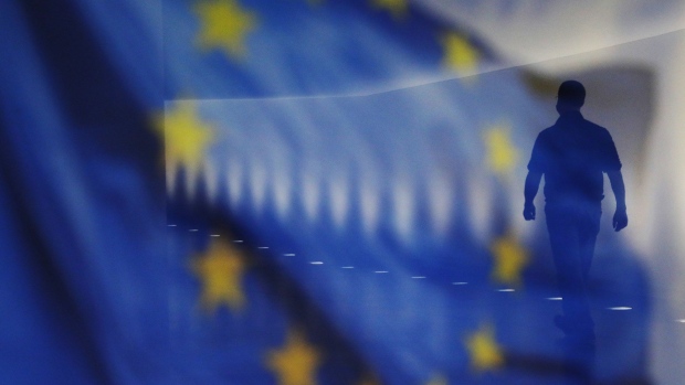 BERLIN, GERMANY - DECEMBER 18: A man walks through the corridor of the German Bundestag as an EU Flag is reflected on a glass Panel on December 18, 2020 in Berlin, Germany. The European Union and the United Kingdom struggles to find an agreement as the Brexit negotiations continue. (Photo by Michele Tantussi/Getty Images)