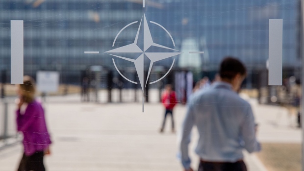 The NATO Star logo sits on a glass panel during the military and political alliance's summit at the North Atlantic Treaty Organization (NATO) headquarters in Brussels, Belgium, on Thursday, July 12, 2018. In an unexpected twist, NATO leaders held an unplanned emergency session on the last day of their two-day summit, which has been upended by U.S. President Donald Trump's attacks on allies over defense spending. Photographer: Marlene Awaad/Bloomberg