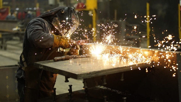 A worker welds a structural steel beam during production at the SME Steel Contractors facility in West Jordan, Utah, U.S., on Feb. 1, 2021. Markit is scheduled to release manufacturing figures on February 3. Photographer: George Frey/Bloomberg