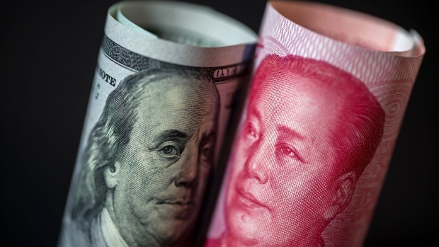 A U.S. one-hundred dollar banknote and a Chinese one-hundred yuan banknote are arranged for a photograph in Hong Kong, China, on Monday, April 15, 2019. China's holdings of Treasury securities rose for a third month as the Asian nation took on more U.S. government debt amid the trade war between the world’s two biggest economies. Photographer: Paul Yeung/Bloomberg