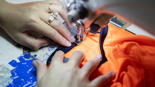 A worker operates a sewing machine at a Thai Son S.P. Co. garment factory in Binh Thuan province, Vietnam, on Friday, Oct. 11, 2019. Vietnam's economic expansion this year may exceed the higher end of an official estimate, President Nguyen Phu Trong said. Growth may be more than 6.8%, and gross domestic product may surpass $266 billion, Trong said in a government statement on Oct. 13. Photographer: Maika Elan/Bloomberg