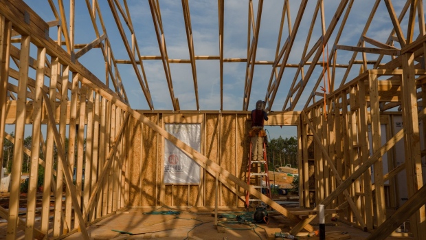 A contractor works on the roof of a house under construction in the Stillpointe subdivision in Sumter, South Carolina, U.S., on Tuesday, July 6, 2021. U.S. pending home sales unexpectedly rose in May by the most in nearly a year as low borrowing costs paired with increased listings bolstered demand.