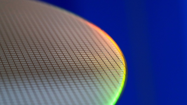 A 300mm silicon wafer at a display area in the semiconductor fabrication (fab) plant, operated by Robert Bosch GmbH in Dresden, Germany, on Monday, May 31, 2021. Bosch agreed to cooperate with Globalfoundries — an Abu Dhabi-owned chip manufacturer with plants in the U.S., Singapore and Germany — to develop automotive radar semiconductors that should hit the market in the second half of this year. Photographer: Krisztian Bocsi/Bloomberg