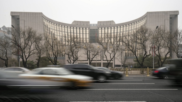 Vehicles travel past the People's Bank of China (PBOC) building in Beijing, China, on Thursday, March 4, 2021. The low cost of borrowing in China’s money markets suggests the central bank again has room to tighten policy by withdrawing liquidity from the financial system -- like it did in January. Photographer: Qilai Shen/Bloomberg