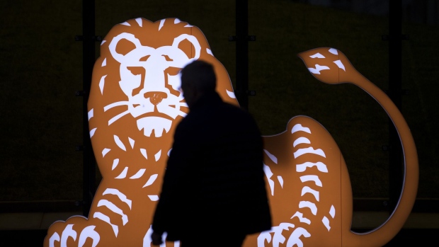 A visitor passes the ING Groep NV lion logo outside the lender's Acanthus headquarter building complex before sunrise in Amsterdam, Netherlands, on Monday, Jan. 29, 2018. The Dutch bank reports full year earnings on Jan. 31. Photographer: Jasper Juinen/Bloomberg