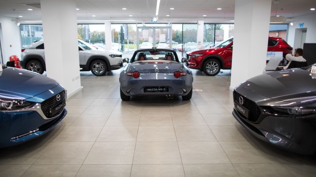 Automobiles manufactured by Mazda Motor Corp., including a MX-5, centre, in the showroom of a dealership, operated by Pentagon Motor Group, a division of Motus Holdings Ltd., in Lincoln, U.K., on Wednesday, Oct. 21, 2020. As the earnings season picks up pace, an improving outlook for carmakers may further boost the sector thats already leading Europes stock rebound since March. Photographer: Chris Ratcliffe/Bloomberg