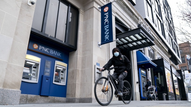 A bicyclist wearing a protective face mask rides past a PNC Bank branch in Washington, D.C., U.S., on Friday, Jan. 8, 2021. PNC Financial Services Group Inc. is scheduled to release earnings figures on January 15. Photographer: Stefani Reynolds/Bloomberg