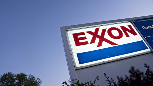 Signage is displayed at an Exxon Mobil Corp. gas station in Arlington, Virginia, U.S., on Wednesday, April 29, 2020. Exxon is scheduled to released earnings figures on May 1. Photographer: Andrew Harrer/Bloomberg