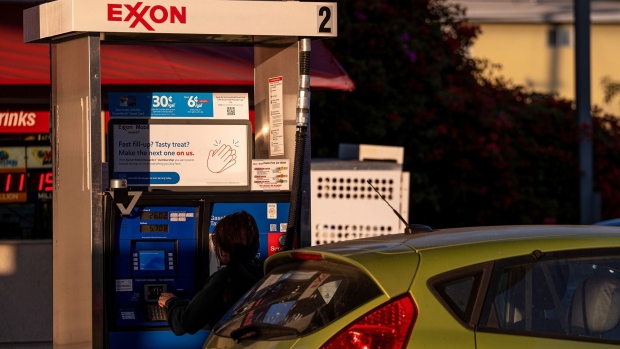 A driver at a fuel pump at an Exxon Mobil gas station in El Cerrito, California, U.S., on Tuesday, July 27, 2021. Exxon Mobil Corp. is expected to release earnings figures on July 30. Photographer: David Paul Morris/Bloomberg