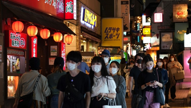 People wearing protective masks walk past bars and cafes in the Shibuya district of Tokyo, Japan, on Saturday, Oct. 9, 2021. In Japan, vaccinations rates are up, infection case are way down, and the emergency lifted at the start of October. Thats boosting optimism that spending may rebound in coming months as new Prime Minister Fumio Kishida launches his administration.