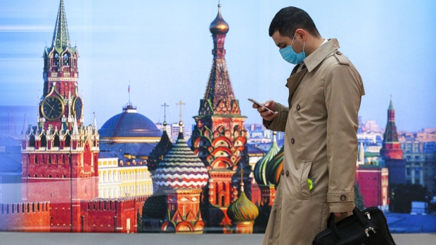 A passenger checks his mobile phone in the departures terminal at Sheremetyevo International Airport OAO in Moscow, Russia, on Friday, Oct. 9, 2020. Russia posted a record number of new Covid-19 cases Friday as the government has resisted returning to a lockdown to battle the second wave of infections. Photographer: Bloomberg/Bloomberg