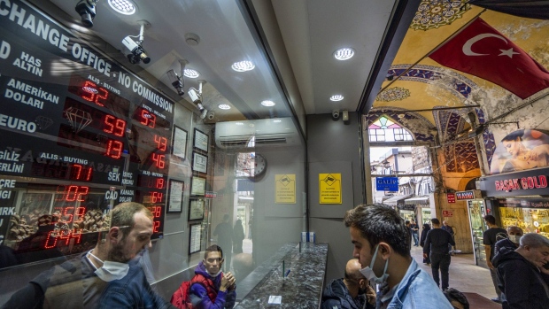 A customer exchanges U.S. dollars at a currency exchange bureau inside the Grand Bazaar in Istanbul, Turkey, on Friday, Oct. 15, 2021. Turkish President Recep Tayyip Erdogan fired monetary policy makers wary of cutting interest rates further, driving the lira to record lows against the dollar with his midnight decree.