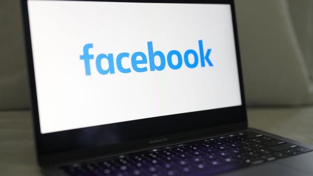 The logo for Facebook is displayed on a laptop computer in an arranged photograph taken in Little Falls, New Jersey, U.S., on Wednesday, Oct. 7, 2020. Facebook Inc. is tightening its rules on content concerning the U.S. presidential election next month, including instituting a temporary ban on political ads when voting ends, as it braces for a contentious night that may not end with a definitive winner.