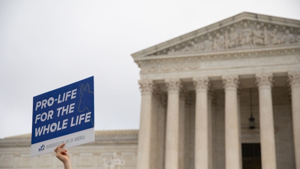 A demonstrator holds a pro-life sign in front of of the U.S. Supreme Court in Washington, D.C., U.S., on Tuesday, Oct. 12, 2021. Louisville's EMW Women's Surgical Center is part of the court's term that could gut the constitutional right to abortion and allow sweeping new restrictions in much of the country. Photographer: Emily Elconin/Bloomberg