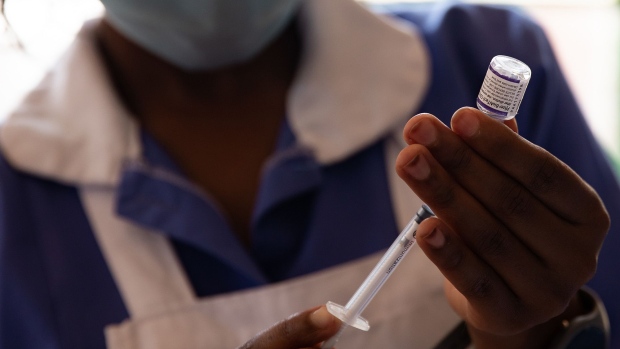 A nurse draws a dose of the Pfizer Coronavirus vaccine before injecting a patient at a school on September 29, 2021 in Kampala.