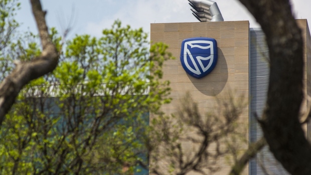 A logo sits on display outside the offices of Standard Bank Group Ltd. bank in Johannesburg, South Africa, on Wednesday, Sept. 23, 2020. South Africa’s biggest lenders were faced with the pressing need to raise provisions to protect against souring loans, while demand for credit slumped as the coronavirus lockdown took a toll on business customers. Photographer: Waldo Swiegers/Bloomberg
