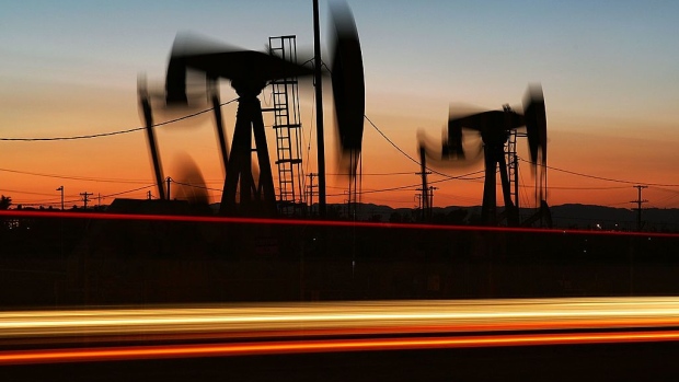 CULVER CITY, CA - APRIL 25: Car lights are seen streaking past an oil rig extracting petroleum as the price of crude oil rises to nearly $120 per barrel, prompting oil companies to reopen numerous wells across the nation that were considered tapped out and unprofitable decades ago when oil sold for one-fifth the price or less, on April 25, 2008 in the Los Angeles area community of Culver City, California. Many of the old unprofitable wells, known as 'stripper wells', are located in urban areas where home owners are often outraged by the noise, smell, and possible environmental hazards associated with living so close to renewed oil drilling. Since homeowners usually do not own the mineral rights under their land, oil firms can drill at an angle to go under homes regardless of the desires of residents. Using expensive new technology and drilling techniques, California producers have reversed a long decline of about 5 percent annually with an increased crude flow of about 2 1/2 million barrels in 2007 for the first time in years. (Photo by David McNew/Getty Images)
