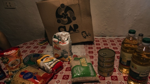 The contents of a bag from the government issued food distribution program, known by the Spanish acronym CLAP, sit on a table at a home in Caracas, Venezuela, on Thursday, Sept. 13, 2018. As the Venezuelan diaspora earns ever greater income, they're sending more to struggling relatives back home. Remittances surged to $1.5 billion in 2017 and will climb a further 60 percent this year to $2.4 billion, according to Caracas-based consultancy Ecoanalitica. Photographer: Adriana Loureiro Fernandez/Bloomberg