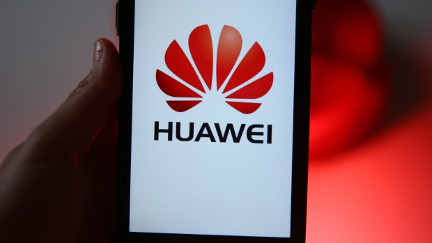 The Huawei Technologies Co. logo sits on display on an Apple Inc. iPhone in this arranged photograph in London, U.K., on Thursday, July 16, 2020. U.K. Prime Minister Boris Johnson faces a diplomatic minefield after banning China’s Huawei from the U.K.’s next-generation wireless networks, as Beijing accused him of breaking promises and Donald Trump claimed credit for the prime minister’s decision. Photographer: Hollie Adams/Bloomberg