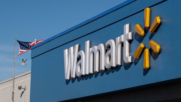 Signage is displayed outside a Walmart store in Lakewood, California, U.S., on Thursday, July 16, 2020. Walmart Inc. will require customers to wear masks in all of its U.S. stores to protect against the coronavirus, an admission that the nation's pandemic has reached new heights and setting up potential confrontations with customers who refuse to don them. Photographer: Patrick T. Fallon/Bloomberg