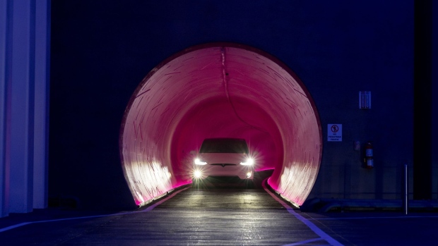 A Tesla Inc. electric vehicle passes through the underground tunnel during a tour of the Boring Co. Convention Center Loop in Las Vegas, Nevada, U.S., on Friday, April 9, 2021. Once operational, Tesla vehicles capable of carrying up to 16 passengers will shuttle through the tunnel, turning a 1.5 mile walk on the surface into a trip that takes a couple of minutes.