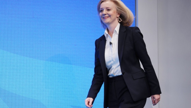 Liz Truss, U.K. foreign secretary, arrives on stage on the first day of the annual Conservative Party conference in Manchester, U.K., on Sunday, Oct. 3, 2021. In a quirk of timing, the Conservative conference is bookended by the phasing out of two major support measures credited with staving off an unemployment crisis and limiting the numbers falling into poverty during the pandemic.