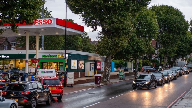 Motorists queue for fuel at an Esso petrol station in London, U.K., on Friday, Oct. 1, 2021. U.K. motorists will have to wait weeks for fuel supply to return to normal, prolonging a shortage that has caused chaos across the country. Photographer: Chris J. Ratcliffe/Bloomberg