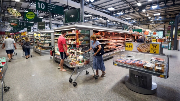 Customers move through a Morrisons supermarket, operated by Wm Morrison Supermarkets Plc, in Saint Ives, U.K., on Monday, July 5, 2021. Apollo Global Management Inc. said Monday it's considering an offer for Morrison, heating up a takeover battle for the U.K. grocer. Photographer: Chris Ratcliffe/Bloomberg