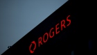 Rogers Communications Inc. signage is illuminated at night on a building in Toronto, Ontario, Canada, on Wednesday, May 17, 2017. Rogers Communications, Canada's largest wireless carrier, is leveraging organic growth in the country's wireless market to expand its subscriber base. Photographer: Brent Lewin/Bloomberg