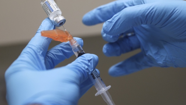 A healthcare worker administers a dose of the Pfizer-BioNTech Covid-19 vaccine at Boston Medical Center in Boston, Massachusetts, U.S., on Thursday, June 17, 2021. The first pandemic surge flooded Boston Medical Center with coronavirus patients: 229 at last spring’s peak, filling nearly two-thirds of its beds. This week, the Covid-19 count hit zero. Photographer: Adam Glanzman/Bloomberg