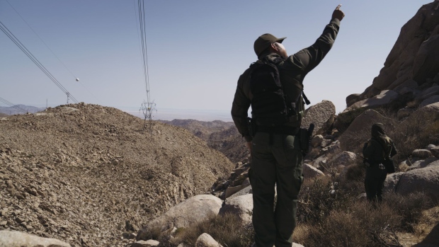 U.S. Border Patrol agents along the U.S. and Mexico border fence near Ocotillo, California, U.S., on Monday, Sept. 13, 2021. The number of undocumented immigrants apprehended trying to cross the southern border is down slightly compared to this time last month, when crossings were at a 21-year high, NBC News reports.