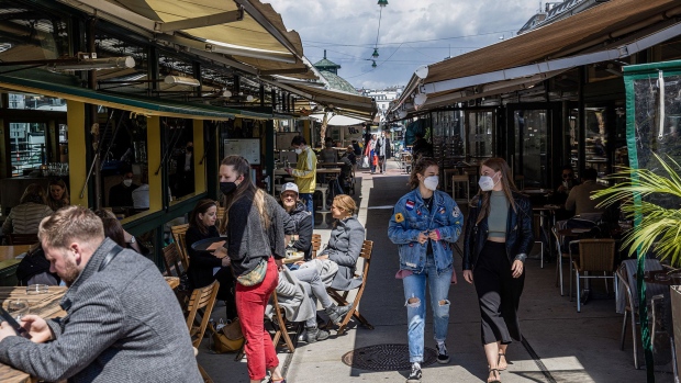 Customers dine at the outside area of a restaurant in the Naschmarkt in Vienna, Austria, on Thursday, May 20, 2021. Western Europe is beginning to loosen restrictions to contain the coronavirus, offering relief for the pandemic-weary region as vaccination programs turn the corner.