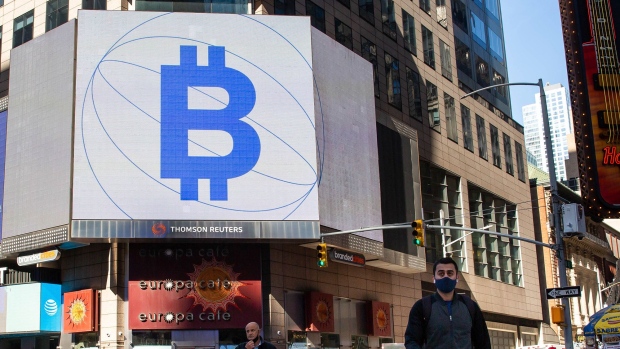 Monitors display Coinbase and Bitcoin signage during the company's initial public offering (IPO) at the Nasdaq MarketSite in New York, U.S., on Wednesday, April 14, 2021. Coinbase Global Inc., the largest U.S. cryptocurrency exchange, is set to debut on Wednesday through a direct listing, an alternative to a traditional initial public offering that has only been deployed a handful of times.